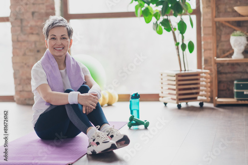 Full size photo of nice retired woman sit mat exercises sportswear sport healthy lifestyle workout modern apartment home living room
