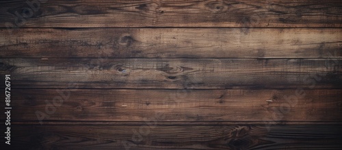 Vintage photo filter applied to an empty dark wooden backdrop with vertical boards The backdrop has a textured wood surface with visible scratches and scrapes on the old paint Ample copy space is ava