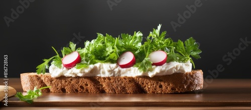 A sandwich made with dark rye bread filled with creamy cottage cheese fresh radishes and parsley copy space image