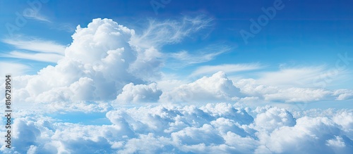 A serene blue sky serves as a backdrop for a panoramic view showcasing a fluffy white cloud with plenty of copy space