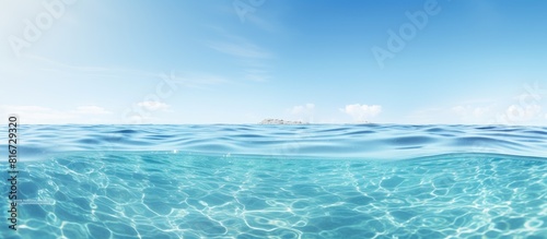 A serene clear sea creates a wide horizontal copy space image perfect for print or web banners with a white room for text The panoramic view offers a calming and relaxing background surface water tex
