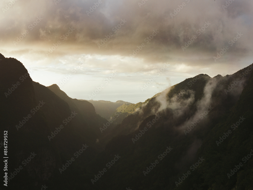 Scenic view of misty mountain peaks with Levada hiking trails in Madeira, Portugal Scenic view of misty mountain peaks with Levada hiking trails in Madeira, Portugal