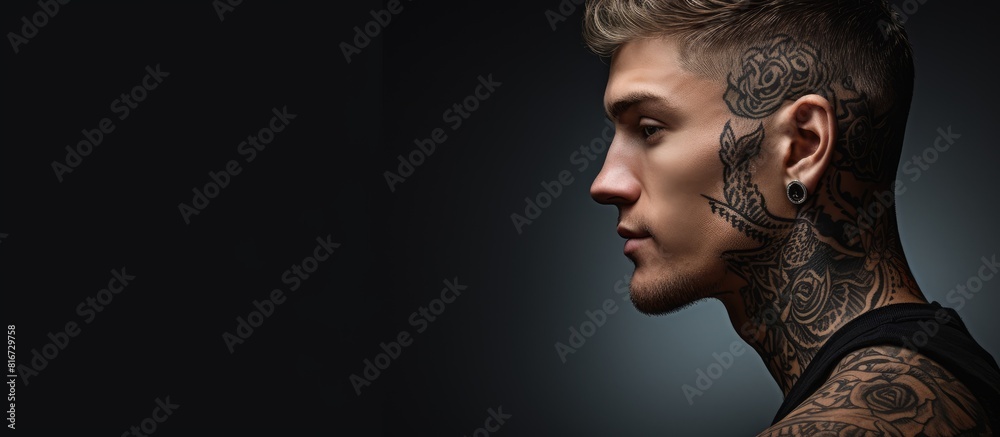A striking young man with a tattoo creating an intriguing copy space image A striking young man with a tattoo creating an intriguing copy space image