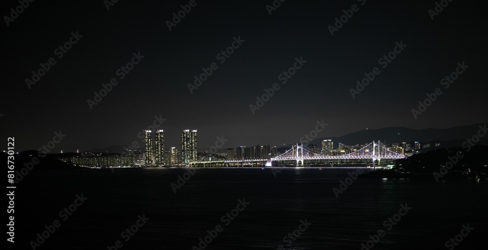 Breathtaking view of a picturesque bridge illuminated at night in the city of Busan, South Korea Breathtaking view of a picturesque bridge illuminated at night in the city of Busan, South Korea