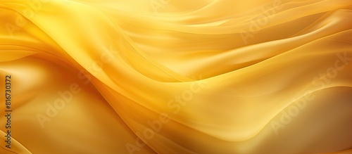 Yellow silk fabric with an abstract amber background is gracefully draped presenting a captivating texture pattern that serves as a design element Enhanced by a copy space image it is well suited for