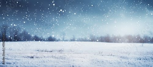Snow falling on the ground creates a natural winter background with ample copy space image © vxnaghiyev