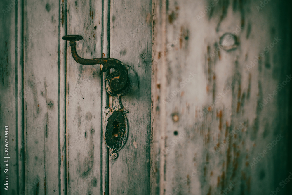 Antique door handle on an old wooden door Antique door handle on an old wooden door