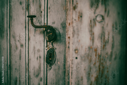 Antique door handle on an old wooden door