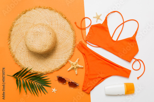 Woman swimwear and beach accessories flat lay top view. Top view with bikini outfit on color background. Vacation concept copy space