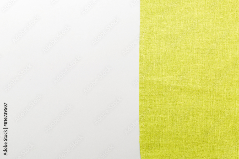Fototapeta premium top view with green kitchen napkin isolated on table background. Folded cloth for mockup with copy space, Flat lay. Minimal style