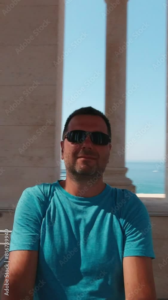 The man takes a selfie video and spins around to show his surroundings. Split, Croatia. Vertical Video