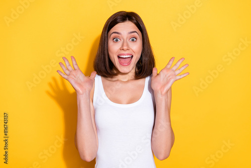 Photo of pretty impressed lady dressed white top screaming rising arms open mouth isolated yellow color background