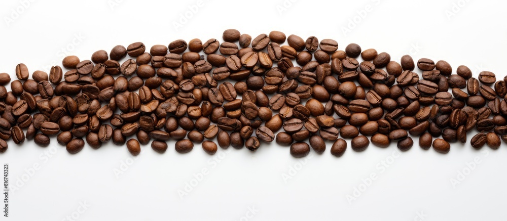 A copy space image of brown coffee beans arranged in the shape of a Christmas tree on a white background A copy space image of brown coffee beans arranged in the shape of a Christmas tree on a white background