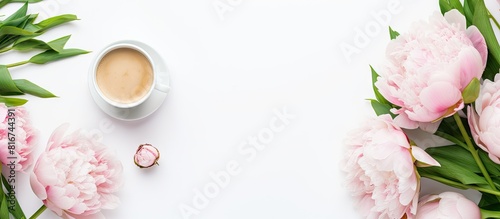 A top view image with copy space showcases a female s morning desktop setup consisting of beautiful peonies a cup of coffee a green notebook a phone and a pen on a white background photo