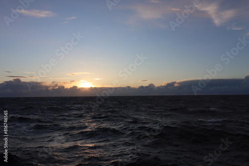 Cruise across the turbulent Atlantic Ocean at dusk