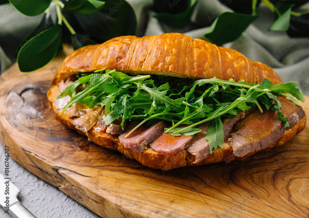 Gourmet croissant sandwich with arugula and ham Gourmet croissant sandwich with arugula and ham