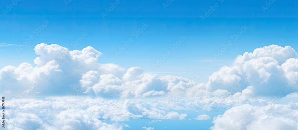 The copy space image showcases a serene atmosphere with a vivid blue sky adorned by fluffy white clouds The copy space image showcases a serene atmosphere with a vivid blue sky adorned by fluffy white clouds