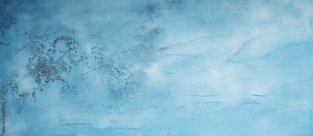 A close up of a rough surface stucco wall with a light blue abstract texture perfect for design projects with copy space image