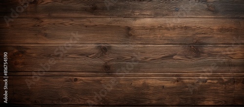 An aged pattern on a dark wooden surface creates a textured background perfect for a copy space image