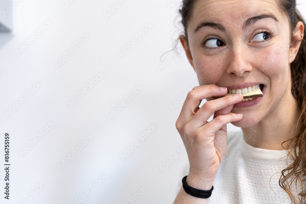 Portrait of charming caucasian woman tasting piece of cheese from cheese plate in home kitchen interior background. People, morning, breakfast and healthy food concept. Portrait of charming caucasian woman tasting piece of cheese from cheese plate in home kitchen interior background. People, morning, breakfast and healthy food concept.