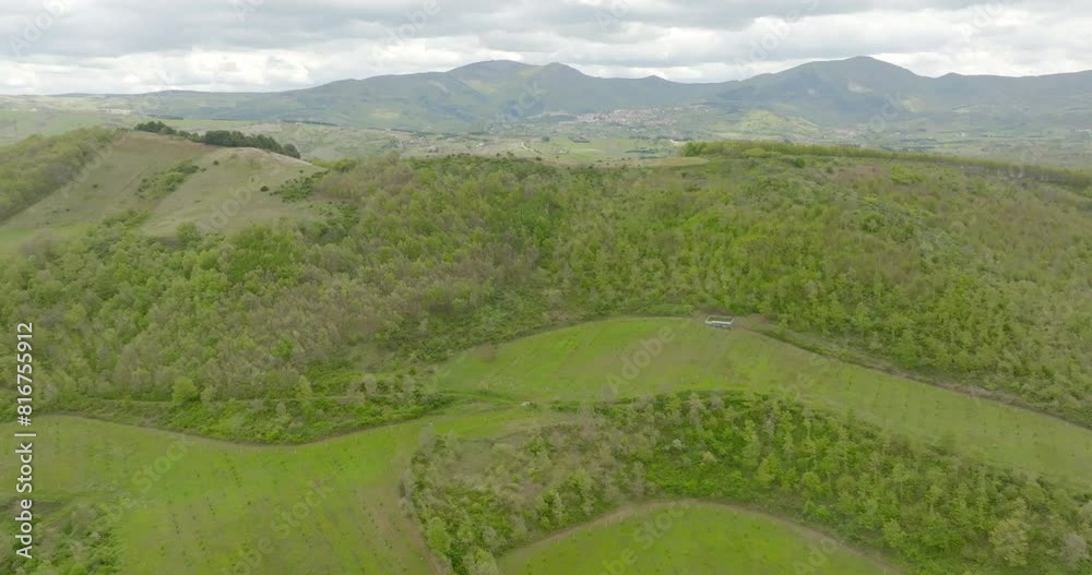 Aerial view on a mountain full of woods and forests. The sky is cloudy. Aerial view on a mountain full of woods and forests. The sky is cloudy.