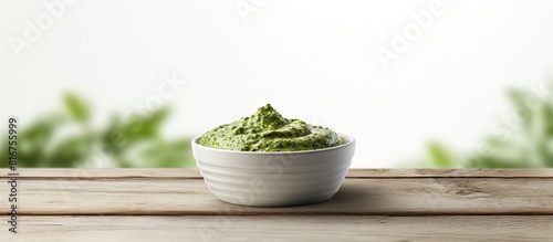 Bowl of pesto on the white wooden table. copy space available