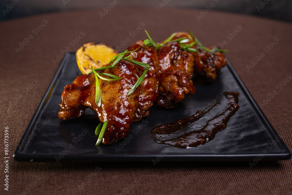 Delicious And Spicy Grilled Chicken Wings With Lemon Garnish Delicious And Spicy Grilled Chicken Wings With Lemon Garnish