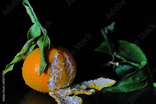 Peeled orange on a dark background photo