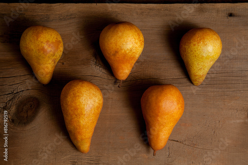 Several pears on wooden background..