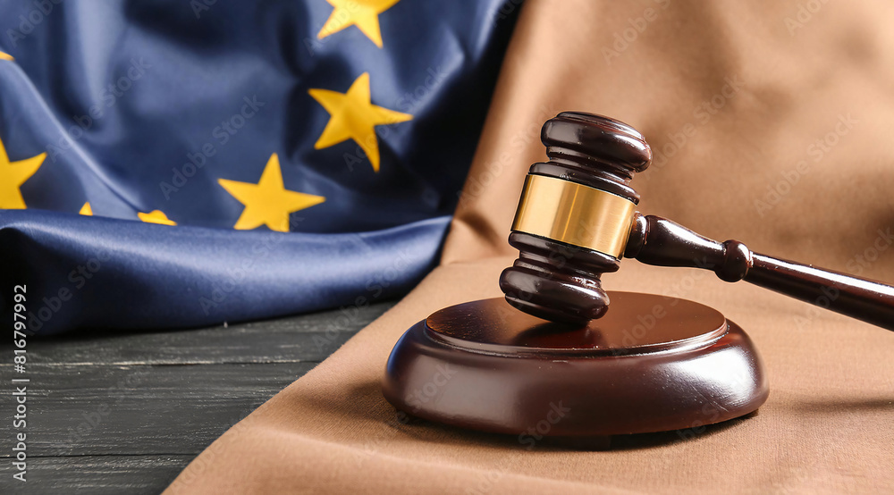 Judges gavel and flag of European Union on black table Judges gavel and flag of European Union on black table