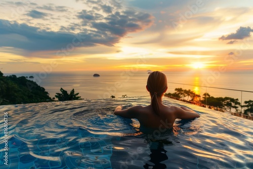 luxury resort vacation woman relaxing in infinity pool jacuzzi enjoying breathtaking ocean sunset view