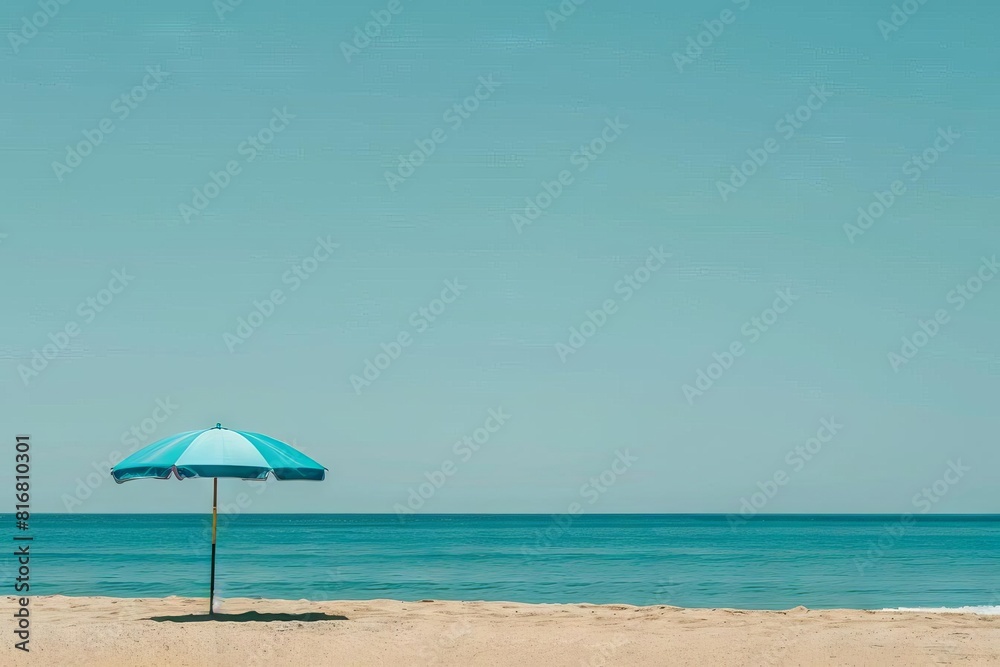 minimalist beach scene with solitary blue umbrella evoking tranquility and solitude against clear sky