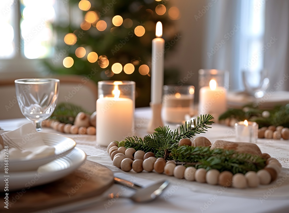 Elegant table setting with candlelight and wooden beads for Christmas dinner, closeup on plates, napkins, cutlery, and candles in the background