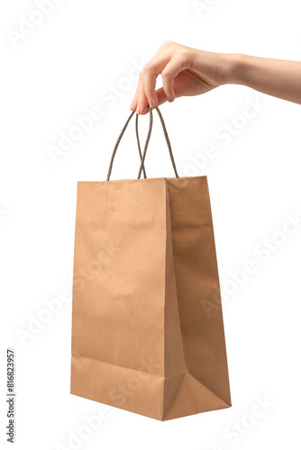 Paper bag in woman hand isolated on a white background.