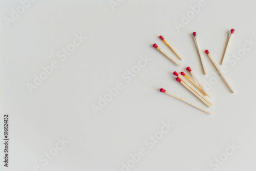 Witness the organized chaos of matchsticks scattered on a white background, representing the potential for ignition and combustion. AI generative technology enhances the realism.