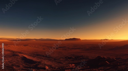 Sunrise over a vast red desert landscape with a clear starry sky.