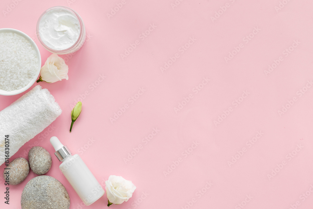 White roses and stones with skin care cosmetics products. Mock up, top view White roses and stones with skin care cosmetics products. Mock up, top view