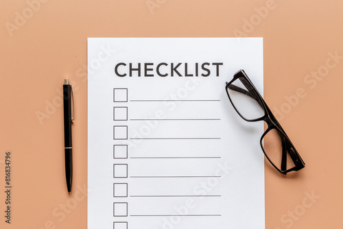 Checklist concept. Blank checklist with empty boxes on office table