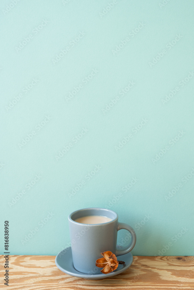 Cup of latte coffee on wooden table. mint wall background