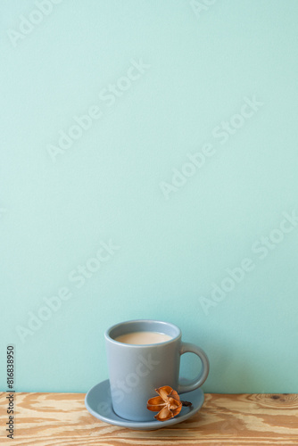 Obraz na płótnie Cup of latte coffee on wooden table. mint wall background w salonie