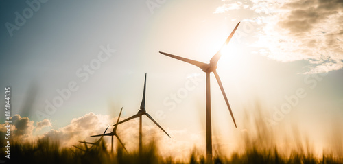 Wind turbines farm, wind power energy generation equipment, clean energy concept. Windmills in the sunlight. Renewable and green energy