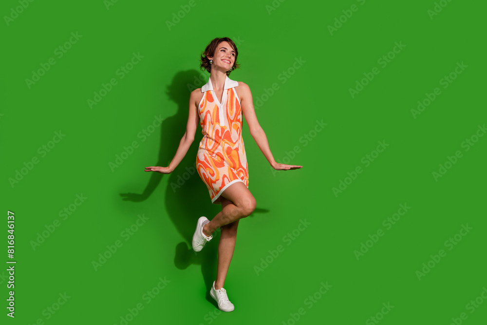Full body photo of lovely young lady feminine posing dressed stylish colorful garment isolated on green color background Full body photo of lovely young lady feminine posing dressed stylish colorful garment isolated on green color background