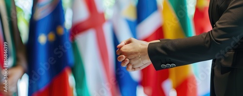 Two diplomats shaking hands with various flags in the background. This image symbolizes international cooperation and diplomacy, highlighting diverse cultural and national representations. photo
