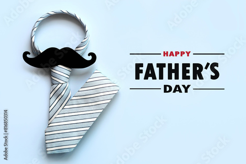 Happy Father's Day. Top view of necktie and false mustache with the text Happy Father's Day