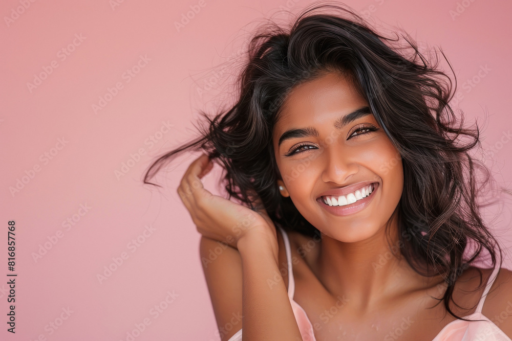 Young beautiful indian woman smiling on pink background Young beautiful indian woman smiling on pink background