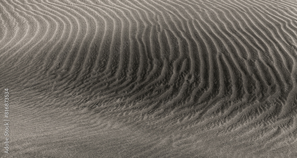 natural sand pattern created by wind blowing differently sized and colored particles natural sand pattern created by wind blowing differently sized and colored particles