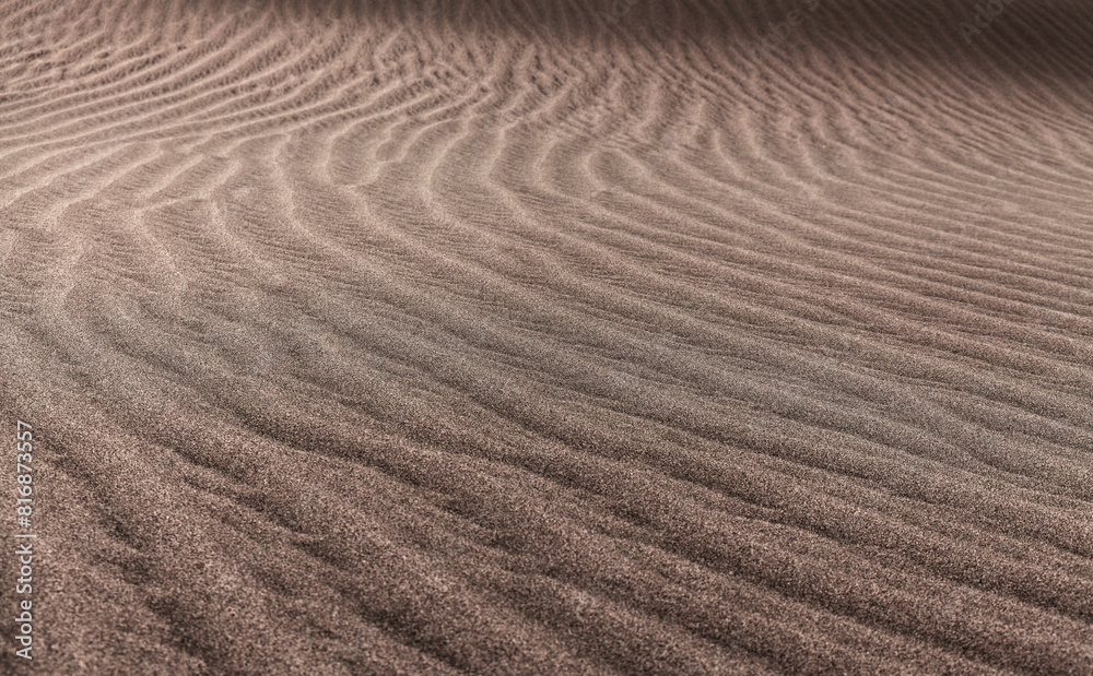 natural sand pattern created by wind blowing differently sized and colored particles natural sand pattern created by wind blowing differently sized and colored particles