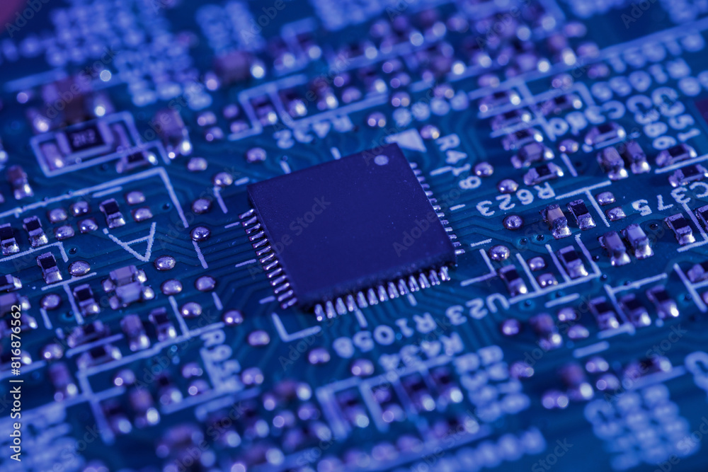 Close-up view of an integrated circuit mounted on a green printed circuit board. Close-up view of an integrated circuit mounted on a green printed circuit board.