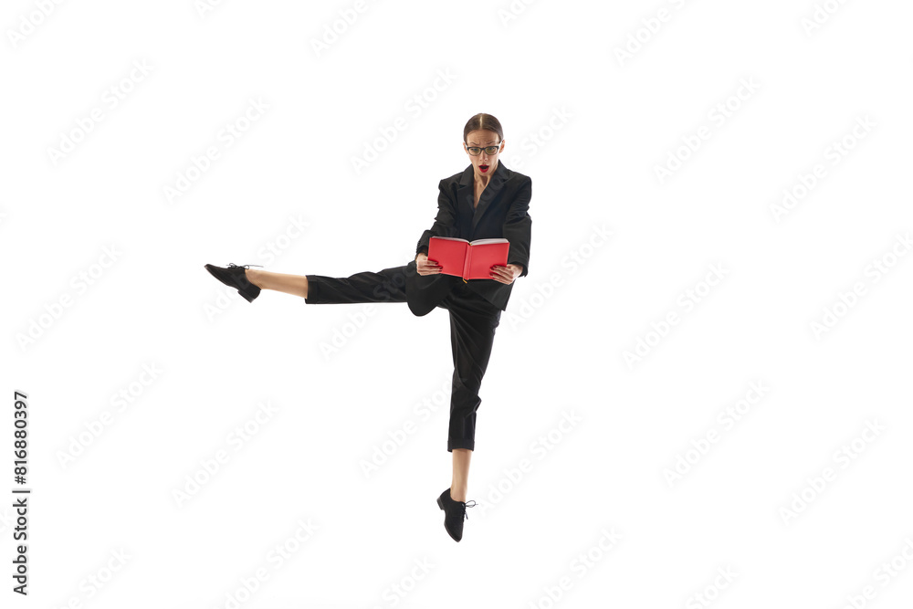 Businesswoman in formal wear emotionally looking on book, notes, standing in mid-air pose isolated on white background. Professional challenges. Concept of business, office lifestyle, human emotions