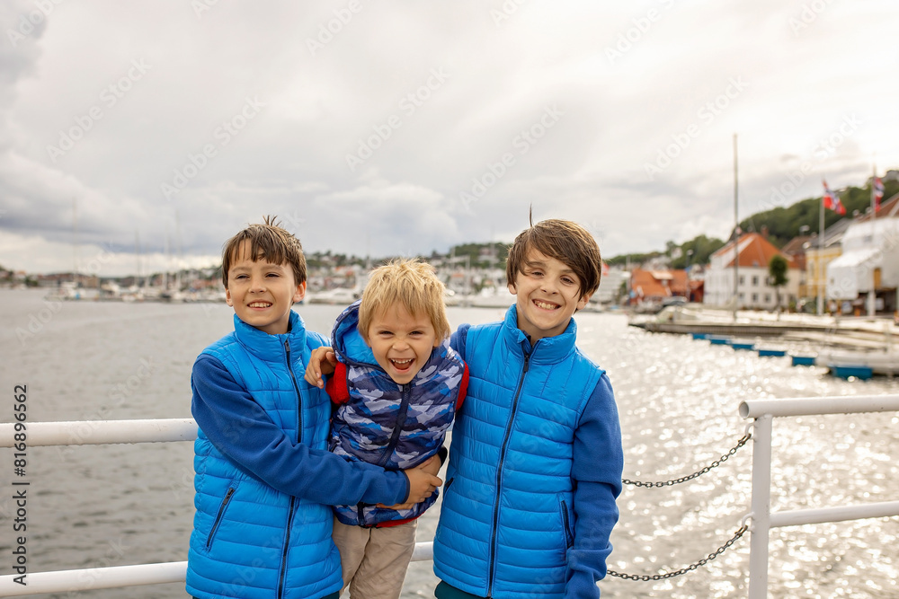 Child, visiting little town in south Norway, Arendal, on a rainy summer day Child, visiting little town in south Norway, Arendal, on a rainy summer day